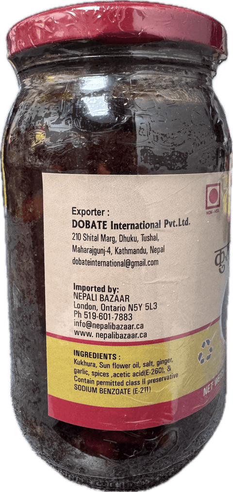 A glass bottle showing Kukhura Achar (Chicken Pickle) from Kalo Kalki of 380g showing ingredients